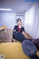 A woman sitting on top of a wooden table.