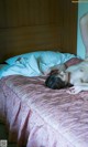 A naked woman laying on a bed in a hotel room.