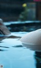 A large white ball floating on top of a pool of water.